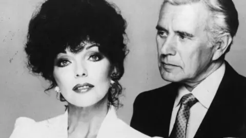 Getty Images Joan Collins and John Forsythe