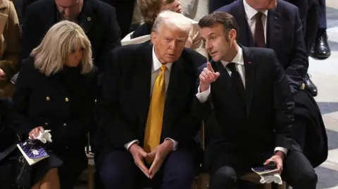 Getty Images Trump at the newly restored Notre Dame Cathedral in Paris