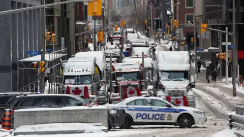 Getty Images Trucks and a police barricade in Ottawa