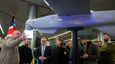 Prime Minister Sir Keir Starmer (centre) and Ukrainian President Volodymyr Zelensky (2nd left) attend a presentation of Ukrainian military drones at an undisclosed location, during his visit to Ukraine to sign a new long-term partnership deal with Volodymyr Zelensky. 