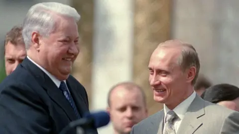 Boris Yeltsin smiling with Vladimir Putin