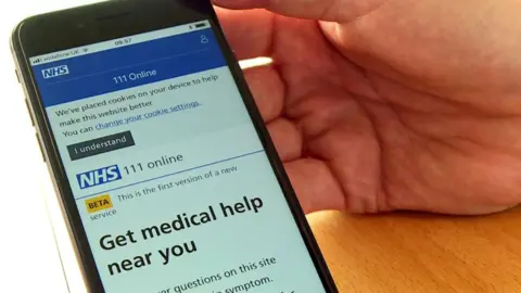 The NHS app is seen on the screen of a smartphone.