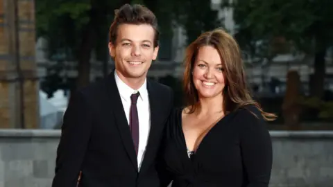 Getty Images Louis Tomlinson with his mother Johannah at the Natural History Museum in 2015