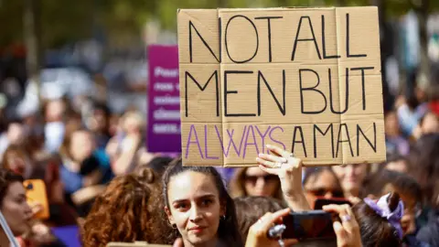 Reuters Demonstrators hold signs at a protest in support of rape victims and Gisele Pelicot, who was allegedly drugged and raped by men solicited by her husband Dominique Pelicot, as the trial continues, at the Place de la Republique in Paris, France, September 14, 2024