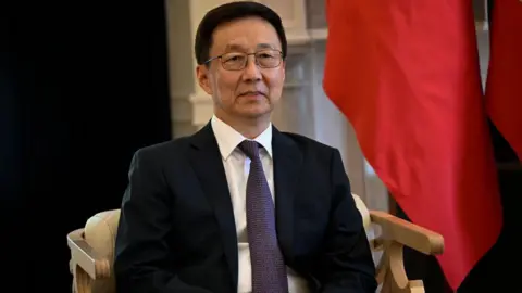 The Vice President of China Han Zheng sits in front of China's and Portugal's national flags upon his arrival for a bilateral meeting at the PM official residence in Sao Bento, on May 08, 2023, in Lisbon, Portugal