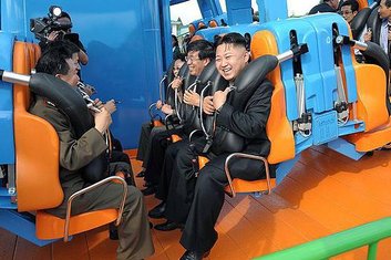 Kim Jong Un reacts on a ride as he attends the completion ceremony of the Rungna People