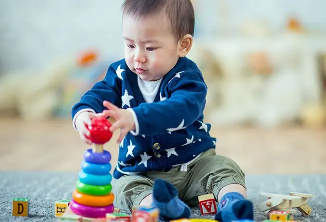 A 10-month-old baby is highly active. At 10 months old, your baby should crawl up steps, hold your hand, climb onto chairs, understand simple sentences, show interest in conversations, imitate people and do many other things. 