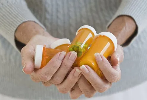 A woman holding medicine bottles.