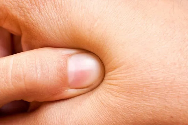 Another spot you can target for tension relief is the fleshy pad between your thumb and first finger.