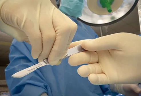 A surgeon with a scalpel about to begin a pancreatic islet cell transplant. 