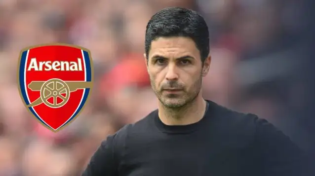 Mikel Arteta, the Arsenal manger, next to the Arsenal badgel