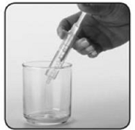 Slowly push the oral syringe plunger all the way down to empty the water from the oral syringe straight into the cup containing the VIGADRONE - Illustration