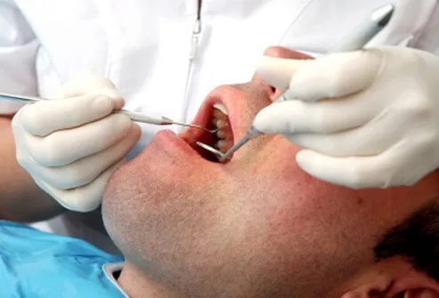  A dentist examines a patient's mouth.