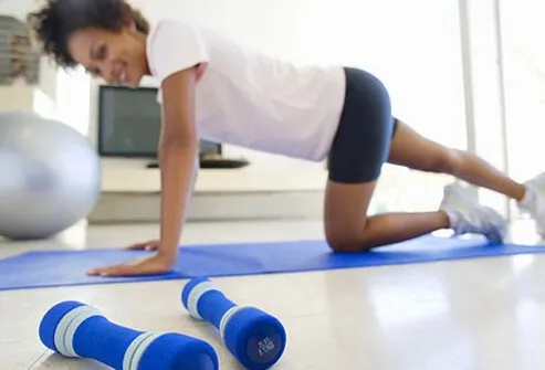 A woman works out at home.