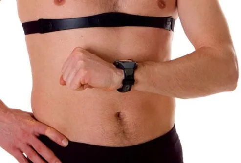 A man checks his heart rate with a heart rate monitor.