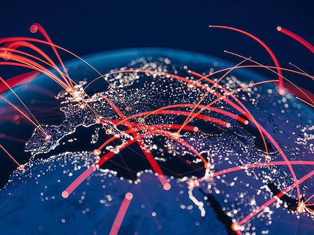 Section of the globe displayed in a schematic way, where luminous red streaks of light symbolize worldwide interconnection.