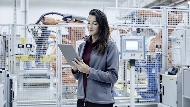 Woman holding a tablet. 