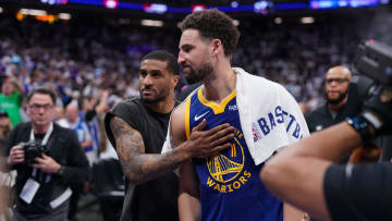Warriors guard Klay Thompson and guard Gary Payton II walk towards the locker room after the Warriors lost to the Sacramento Kings during a play-in tournament game.