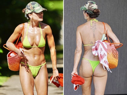 Rita Ora On The Beach In Australia In A Neon Green Bikini And a Camo Hat