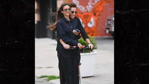 Nina Dobrev and Shaun White ride a scooter