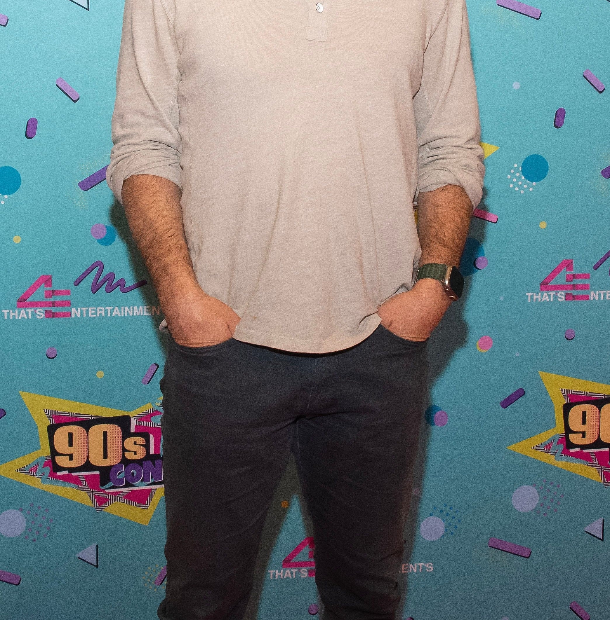 Mark-Paul Gosselaar on the red carpet wearing a Henley shirt and eyeglasses