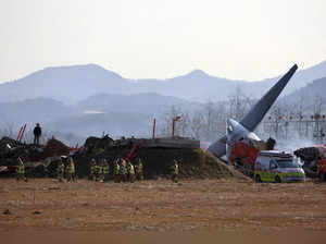 Firefighters and rescue team members work at Muan International Airport in Muan,...