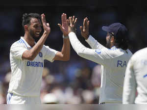 India's Prasidh Krishna, left, celebrates with teammate KL Rahul after taking th...