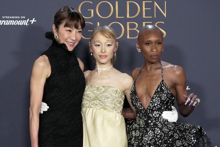 Michelle Yeoh (left), Ariana Grande (center) and Cynthia Erivo (right), winners of Cinematic and Box Office Achievement for "Wicked," pose in the press room at the 82nd Annual Golden Globe Awards.