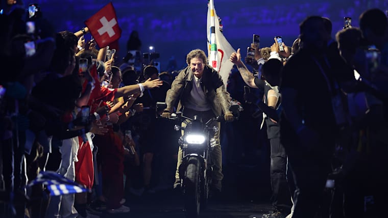 American actor and film producer Tom Cruise rides on a motorbike with the Olympic Flag during the Closing Ceremony of the Olympic Games Paris 2024 at Stade de France on August 11, 2024 in Paris, France