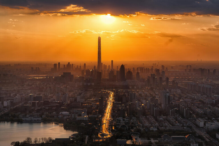 Sun over a city skyline.