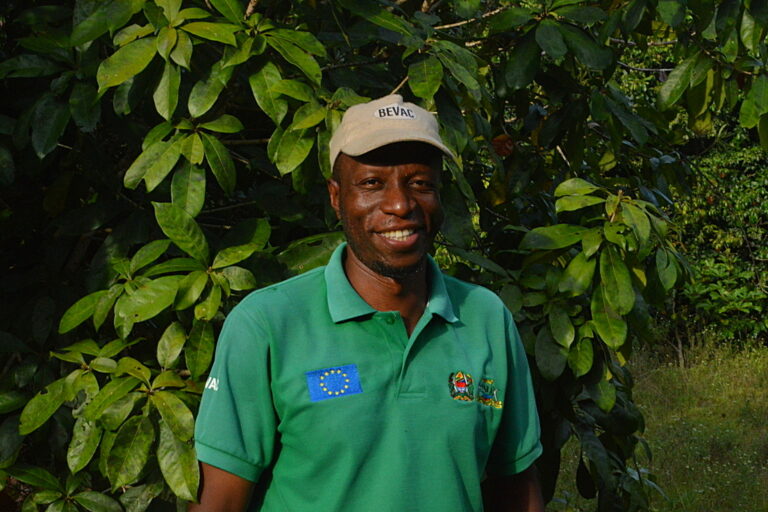 Khamis Ali Khamis, acting-chief-in-charge of Ngezi Forest Reserve, wearing a brown peaked cap and green t-shirt, smiles at the camera. Image by Ryan Truscott for Mongabay.