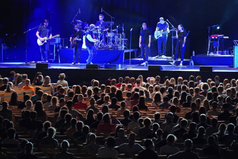 LEIPZIG, GERMANY - AUGUST 22: Participants wearing FFP2 protective face masks watch singer Tim Bendzko perform in the RESTART-19 Covid transmission risk assessment study in a concert setting at an indoor arena during the coronavirus pandemic on August 22, 2020 in Leipzig, Germany. The study, organized by the University Hospital of Halle (Saale), simulates a live concert venue with several thousand audience members in three different scenarios in order to develop risk reduction measures for large events. Participants wear tracer devices to track their movements and sensors measure aerosol currents in the arena. All participants had to undergo a Covid-19 test within the last 48 hours and test negative in order to take part. (Photo by Sean Gallup/Getty Images)