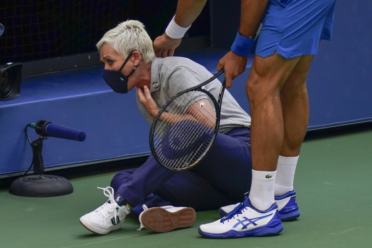 Novak Djokovic, of Serbia, checks a line judge after inadvertently hitting her with a ball in reaction to losing a point to Pablo Carreno Busta, of Spain, during the fourth round of the US Open tennis championships, Sunday, Sept. 6, 2020, in New York. Djokovic defaulted the match. (AP Photo/Seth Wenig)