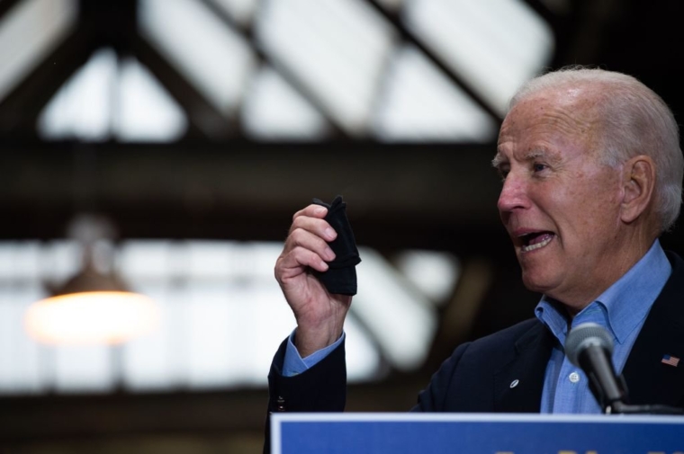 Democratic presidential candidate Joe Biden shows his mask as he speaks about PPE use at the Pittsburgh train station in Pittsburgh, Pennsylvania, on September 30, 2020, during a train campaign tour. - Biden on Wednesday branded his presidential rival's caustic debate performance as a "national embarrassment" for not addressing concerns of everyday Americans and failing to clearly denounce white supremacist groups. (Photo by ROBERTO SCHMIDT / AFP) (Photo by ROBERTO SCHMIDT/AFP via Getty Images)