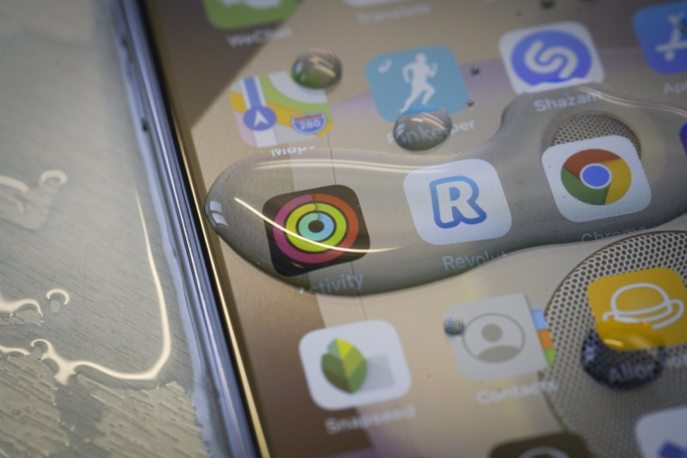 An Apple iPhone 11 Pro Max is seen covered in water droplets after being washed in Warsaw, Poland on March 18, 2020. Health authorities have advised people to wash their hands and their phones with soap if possible to combat the spread of the coroanvirus. (Photo by Jaap Arriens/NurPhoto via Getty Images)