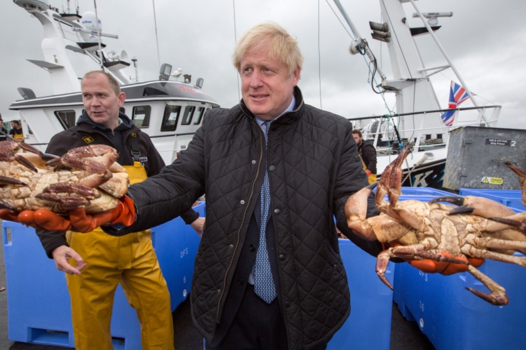 Prime Minister Boris Johnson holds crabs caught on the Carvela with Karl Adamson at Stromness Harbour in Stromness during a visit to the Highlands and Northern Isles of Scotland. PA Photo. Picture date: Thursday July 23, 2020. See PA story POLITICS Johnson. Photo credit should read: Robert Perry/PA Wire