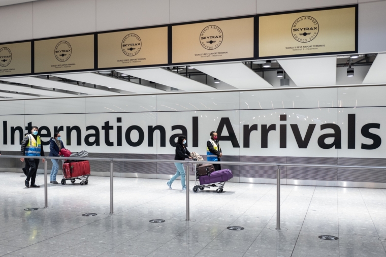 LONDON, ENGLAND - FEBRUARY 16: Passengers travelling from one of the countries on the "red list" are escorted through the arrivals area of terminal 5 of Heathrow airport and onto a waiting coach, on February 16, 2021 in London, England. From yesterday, people arriving from 33 "red list" countries, including South Africa and the United Arab Emirates, must isolate in hotels rooms for 10 days at their own expense. The policy was announced late last month in response to the emergence of new variants of the novel coronavirus that are more resistant to existing vaccines. (Photo by Leon Neal/Getty Images)