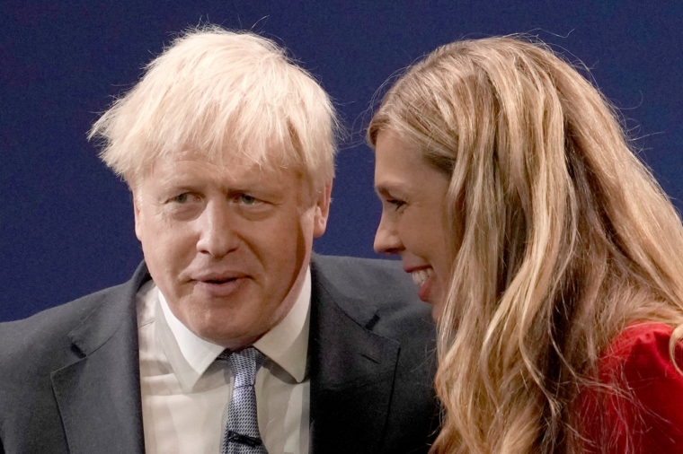 MANCHESTER, ENGLAND - OCTOBER 06: Britain's Prime Minister Boris Johnson and wife Carrie Johnson after delivering his keynote speech during the Conservative Party conference at Manchester Central Convention Complex on October 6, 2021 in Manchester, England. This year's Conservative Party Conference returns as a hybrid of in-person and online events after last year it was changed to a virtual event due to the Coronavirus pandemic. Boris Johnson addresses the party as its leader for the third time. (Photo by Christopher Furlong/Getty Images)