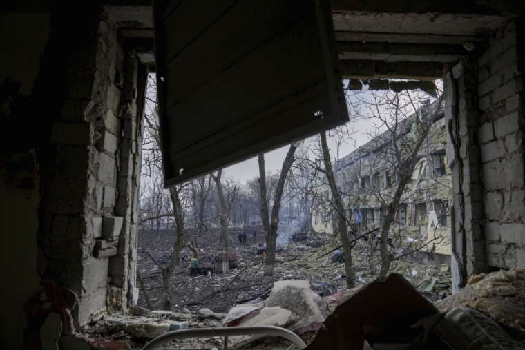 Ukrainian emergency employees work at the side of the damaged by shelling maternity hospital in Mariupol, Ukraine, Wednesday, March 9, 2022. A Russian attack has severely damaged a maternity hospital in the besieged port city of Mariupol, Ukrainian officials say. (AP Photo/Evgeniy Maloletka)