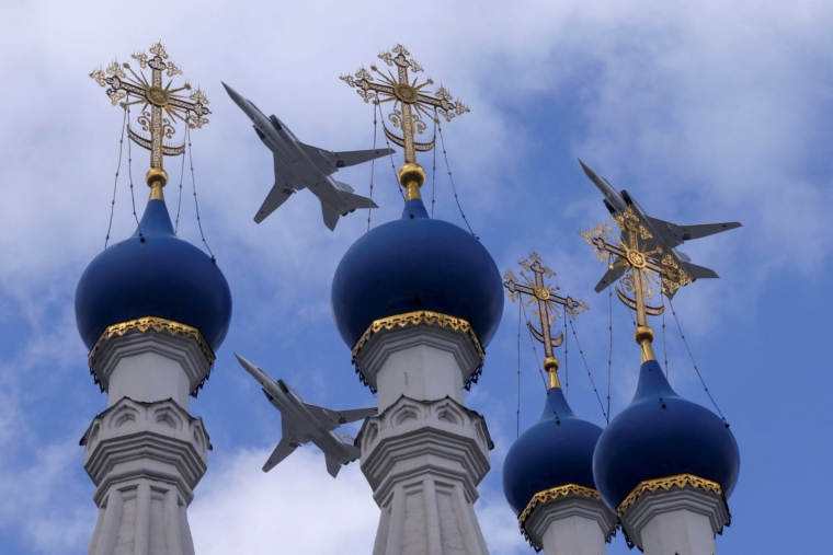 Russian Tu-22M3 bombers fly in formation above a church during a rehearsal for the flypast, which is part of a military parade marking the anniversary of the victory over Nazi Germany in World War Two, in Moscow, Russia May 4, 2022. REUTERS/Maxim Shemetov