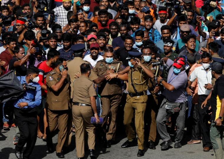 FILE PHOTO: Policemen run for cover as protestors chase them during a protest organised by students near the President's House, amid the country's economic crisis, in Colombo, Sri Lanka, May 19, 2022. REUTERS/Adnan Abidi/File Photo