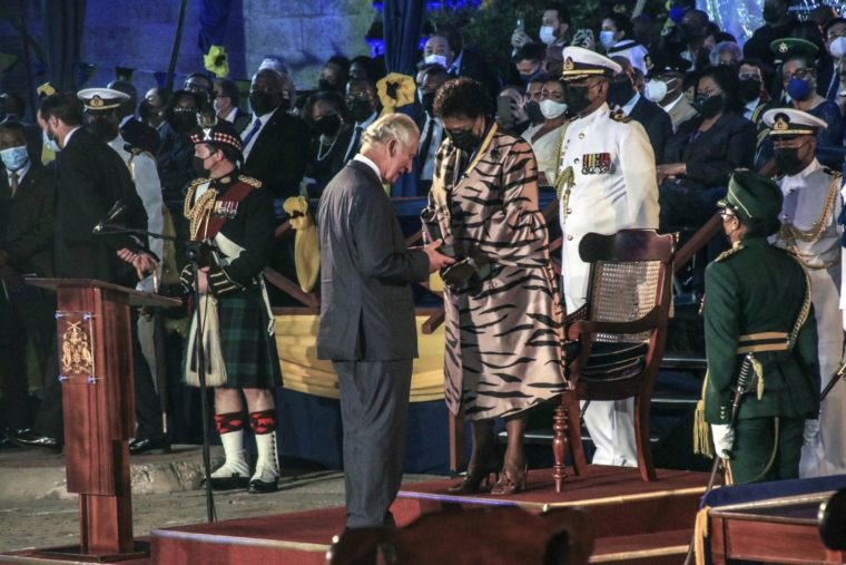 FILE - Barbados' new President Sandra Mason, center right, awards Prince Charles with the Order of Freedom of Barbados, during the presidential inauguration ceremony in Bridgetown, Barbados on Tuesday Nov. 30, 2021. After seven decades on the throne, Queen Elizabeth II is widely viewed in the U.K. as a rock in turbulent times. But in Britain???s former colonies, many see her as an anchor to an imperial past whose damage still lingers. (AP Photo/David McD Crichlow, File)