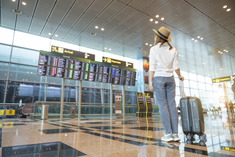 Rear tourist woman at international airport