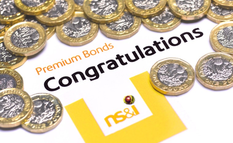 LONDON,ENGLAND - AUGUST 7: In this photo illustration, a Premium Bond congratulatory note and pound coins on August 7,2020 in London,England. Premium Bonds are a lottery bond issued by the government's National Savings and Investments (NS&I) agency. (Photo by Peter Dazeley/Getty Images)