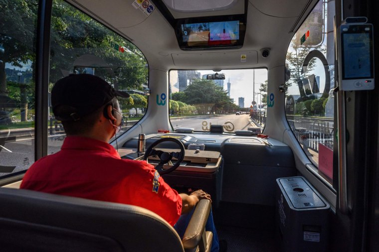 A safety driver monitors a self-driving minibus during its trial operation in Guangzhou in China's southern Guangdong province on July 26, 2022. (Photo by AFP) / China OUT (Photo by STR/AFP via Getty Images)