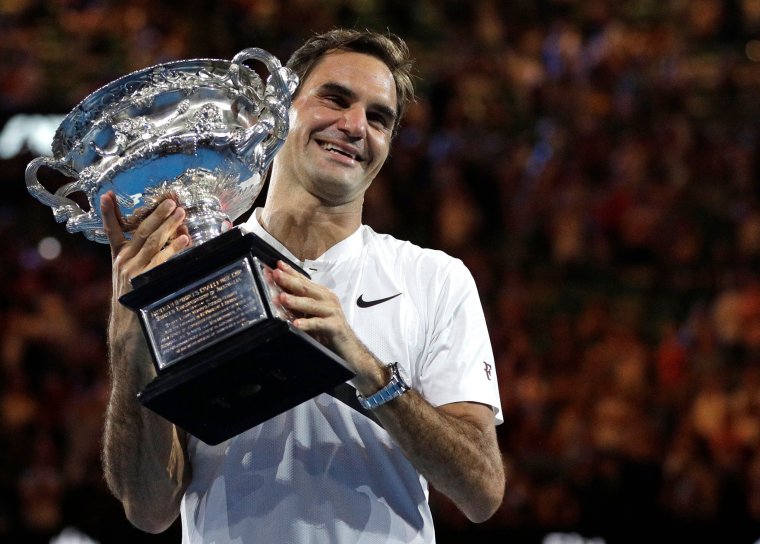 FILE - Switzerland's Roger Federer holds his trophy after defeating Croatia's Marin Cilic during the men's singles final at the Australian Open tennis championships in Melbourne, Australia, Sunday, Jan. 28, 2018. Federer announced Thursday, Sept.15, 2022 he is retiring from tennis. (AP Photo/Dita Alangkara, File)