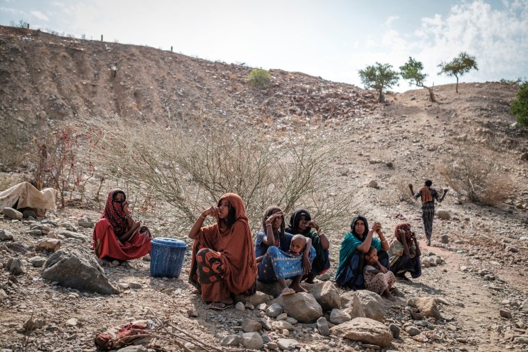 Internally displaced women seat in the makeshift camp where they are sheltered in the village of Erebti, Ethiopia, on June 09, 2022. - The Afar region, the only passageway for humanitarian convoys bound for Tigray, is itself facing a serious food crisis, due to the combined effects of the conflict in northern Ethiopia and the drought in the Horn of Africa which have notably caused numerous population displacements. More than a million people need food aid in the region according to the World Food Programme. (Photo by EDUARDO SOTERAS / AFP) (Photo by EDUARDO SOTERAS/AFP via Getty Images)