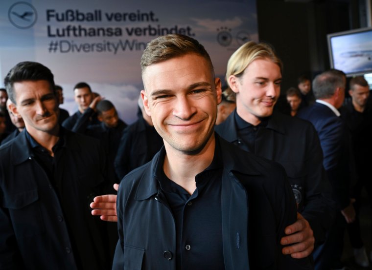 Germany's national team players Joshua Kimmich, center, and Julian Brandt, right, attend a farewell ceremony at the Lufthansa First Class terminal prior to boarding a plane to Muscat, Oman, for a short training camp ahead of the upcoming upcoming Soccer World Cup in Qatar, at Frankfurt's airport, Germany, Monday, Nov. 14, 2022. The World Cup begins Nov. 22. (Arne Dedert/Pool Photo via AP)