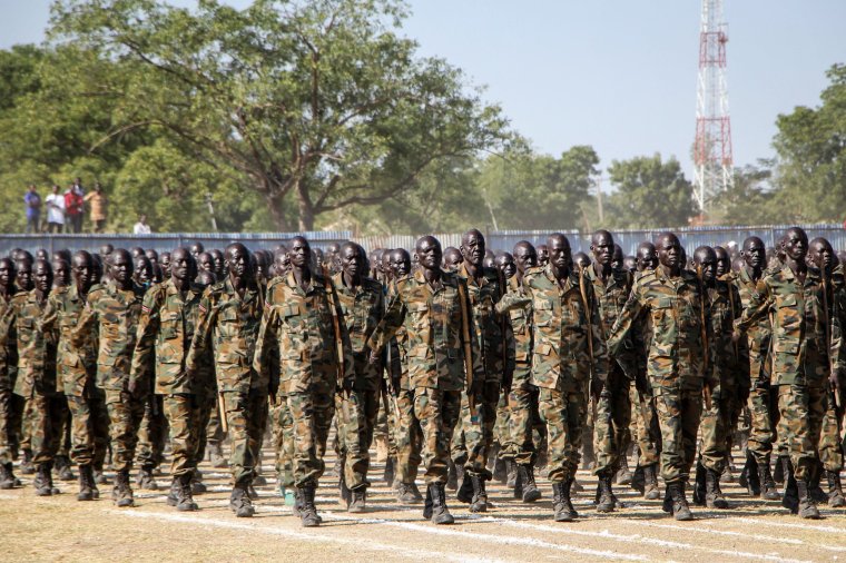 New members of South Sudan People's Defence Forces (SSPDF) of the Unified Forces perform with handmade wooden rifles or sticks during the graduation ceremony in Malakal on November 21, 2022. - About nine thousand members including former soldiers of rebels in South Sudan's civil war were integrated into the country's Unified Forces after more than 3 years of training. (Photo by Samir Bol / AFP) (Photo by SAMIR BOL/AFP via Getty Images)