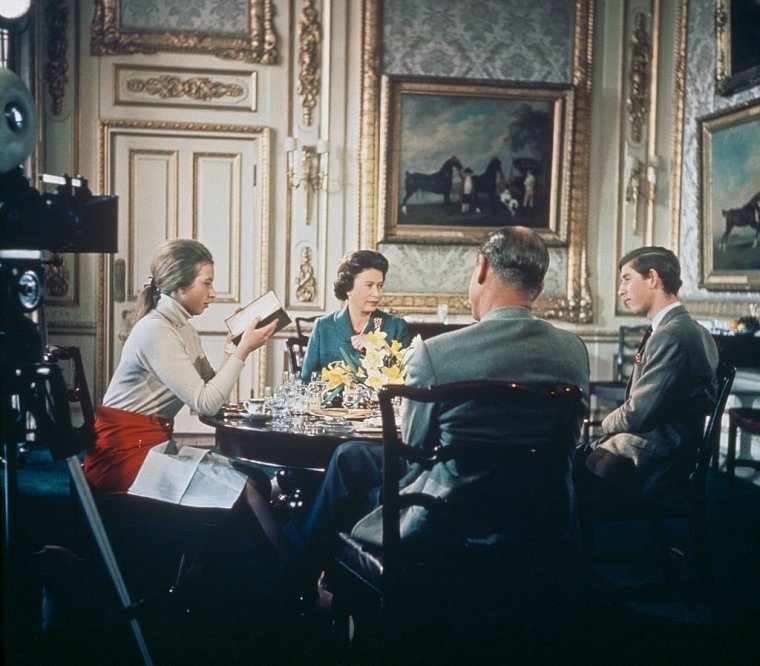 Queen Elizabeth II lunches with Prince Philip and their children Princess Anne and Prince Charles at Windsor Castle in Berkshire, circa 1969. A camera (left) is set up to film for Richard Cawston's BBC documentary 'Royal Family', which followed the Royal Family over a period of a year and was broadcast on 21st June 1969. (Photo by Hulton Archive/Getty Images)